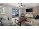 Bright living room featuring modern decor, wood-look flooring, and sliding glass doors to the outdoor pool area at 2142 Ibis, Clearwater, FL 33764