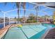 Inviting pool area with a screened enclosure and waterfront view at 2142 Ibis, Clearwater, FL 33764