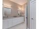 Bathroom with double vanity, dual sinks, sleek countertops, and contemporary mirrors and lighting at 2150 43Rd N Ter, St Petersburg, FL 33714