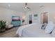 Relaxing bedroom features light-colored wood-look flooring, dresser, ceiling fan, and an ensuite bathroom at 2150 43Rd N Ter, St Petersburg, FL 33714