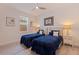 Comfortable bedroom with two twin beds, soft lighting, and stylish decor for a cozy space at 2150 43Rd N Ter, St Petersburg, FL 33714