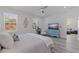 Bright primary bedroom featuring light-colored floors, a ceiling fan, and an ensuite bathroom at 2150 43Rd N Ter, St Petersburg, FL 33714