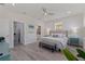 A primary bedroom featuring light-colored floors, a ceiling fan, and an ensuite bathroom and closet at 2150 43Rd N Ter, St Petersburg, FL 33714