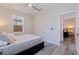 Bright bedroom with sleek gray floors, a modern ceiling fan, and a view into the next room at 2150 43Rd N Ter, St Petersburg, FL 33714