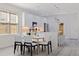 Modern dining area with a stylish table, comfortable seating, and an open view to the well-equipped kitchen at 2150 43Rd N Ter, St Petersburg, FL 33714