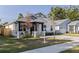 Charming single-Gathering home showcasing modern design, complemented by lush greenery and curb appeal at 2150 43Rd N Ter, St Petersburg, FL 33714