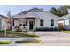 Charming home with a well-manicured lawn, stylish black and white accents, and a welcoming front entrance at 2150 43Rd N Ter, St Petersburg, FL 33714