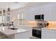 Modern kitchen with stainless steel appliances, bright white cabinets, and a stylish marble countertop island at 2150 43Rd N Ter, St Petersburg, FL 33714