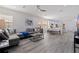 Bright and airy living room with a large sectional sofa, stylish decor, and an open layout to the dining area at 2150 43Rd N Ter, St Petersburg, FL 33714