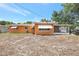 Exterior view of the back of the home showing a porch and spacious yard at 3065 Merrill Ave, Clearwater, FL 33759