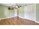 This bedroom offers wood-look laminate floors, closet, and a ceiling fan at 3065 Merrill Ave, Clearwater, FL 33759