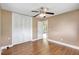 Bedroom with wood-look laminate floors, closet, ceiling fan, fresh paint, and natural light at 3065 Merrill Ave, Clearwater, FL 33759