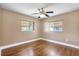 Bright bedroom featuring wood-look laminate floors, ceiling fan and natural light at 3065 Merrill Ave, Clearwater, FL 33759