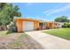 Single-story home featuring a garage, well-kept lawn, and a sunny disposition at 3065 Merrill Ave, Clearwater, FL 33759