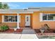 Charming front entryway of home with white trim, an oval-window door, and plants at 3065 Merrill Ave, Clearwater, FL 33759