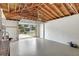 A spacious garage with an open door, exposed ceiling and a sealed concrete floor at 3065 Merrill Ave, Clearwater, FL 33759