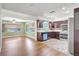 Bright kitchen connects to living area, featuring stainless appliances, and tiled floors at 3065 Merrill Ave, Clearwater, FL 33759