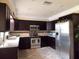 A beautifully appointed kitchen with stainless steel appliances and dark wood cabinetry at 3065 Merrill Ave, Clearwater, FL 33759