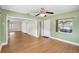 Cozy living room with fresh paint, laminate wood floors, ceiling fan, and natural light at 3065 Merrill Ave, Clearwater, FL 33759