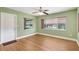 Living room with laminate wood floors, a ceiling fan, fresh paint, and natural light at 3065 Merrill Ave, Clearwater, FL 33759