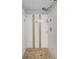 Shower featuring elegant white tiling with decorative mosaic accents and crystal handle at 3065 Merrill Ave, Clearwater, FL 33759