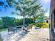 Backyard featuring pavers, a fire pit with seating, manicured landscaping and playground at 3212 55Th E St, Palmetto, FL 34221