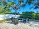 Backyard featuring pavers, a fire pit with seating, and manicured landscaping at 3212 55Th E St, Palmetto, FL 34221