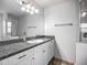Bathroom features white cabinets, granite countertops, and updated mirror and light fixtures at 3212 55Th E St, Palmetto, FL 34221