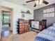 Bedroom featuring a crib and bed with a shelf, drawers and view to other parts of the house at 3212 55Th E St, Palmetto, FL 34221
