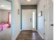 Hallway with wood floors leading to a bedroom featuring pink curtains and a bright decor at 3212 55Th E St, Palmetto, FL 34221