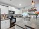 Charming kitchen with white cabinetry, stainless steel appliances, and attractive backsplash at 3212 55Th E St, Palmetto, FL 34221