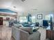 Open-concept living room featuring hardwood floors, a ceiling fan, and lots of natural light at 3212 55Th E St, Palmetto, FL 34221