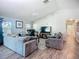Open-concept living room with a ceiling fan, hardwood floors, and a large TV at 3212 55Th E St, Palmetto, FL 34221