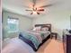 Relaxing bedroom with decorative pillows, ceiling fan and dresser at 3212 55Th E St, Palmetto, FL 34221