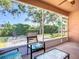 Relaxing screened patio with comfortable seating and a view of the backyard and playset at 3212 55Th E St, Palmetto, FL 34221