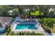 Aerial view of the community pool featuring a pool house, lounge chairs and landscaping at 3212 55Th E St, Palmetto, FL 34221