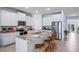 Modern kitchen with stainless steel appliances, granite countertops, and a breakfast bar with stools at 32450 Osprey Peak Way, San Antonio, FL 33576