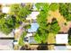 Aerial view of a home surrounded by mature trees and neighboring properties at 3306 E Chelsea St, Tampa, FL 33610