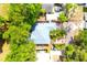 Aerial view of a home surrounded by mature trees and neighboring properties at 3306 E Chelsea St, Tampa, FL 33610