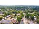 A neighborhood from above featuring a mix of homes and community buildings surrounded by mature trees at 3306 E Chelsea St, Tampa, FL 33610