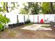 Backyard with sparse landscaping, and a concrete patio at 3306 E Chelsea St, Tampa, FL 33610