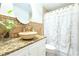 Charming bathroom featuring decorative tile backsplash, vessel sink, and a shower at 3306 E Chelsea St, Tampa, FL 33610