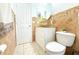 Well lit bathroom featuring decorative tile backsplash, vessel sink, and a toilet at 3306 E Chelsea St, Tampa, FL 33610