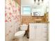 Cozy bathroom with a floral shower curtain, updated vanity, and neutral tile work at 3306 E Chelsea St, Tampa, FL 33610