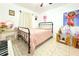 Comfortable bedroom with light pink bedding, tile floors and colorful wall decor at 3306 E Chelsea St, Tampa, FL 33610