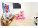 Bright bedroom featuring a television, play area and neutral walls at 3306 E Chelsea St, Tampa, FL 33610
