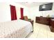 Comfortable bedroom features neutral walls, closet, and television at 3306 E Chelsea St, Tampa, FL 33610