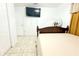 Cozy bedroom featuring a bed, white walls, and tiled flooring at 3306 E Chelsea St, Tampa, FL 33610