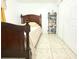 Bright bedroom featuring a wooden bed frame, white walls, and tiled flooring at 3306 E Chelsea St, Tampa, FL 33610