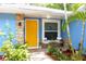 Beautiful home entrance featuring a vibrant yellow door and stylish stone details at 3306 E Chelsea St, Tampa, FL 33610